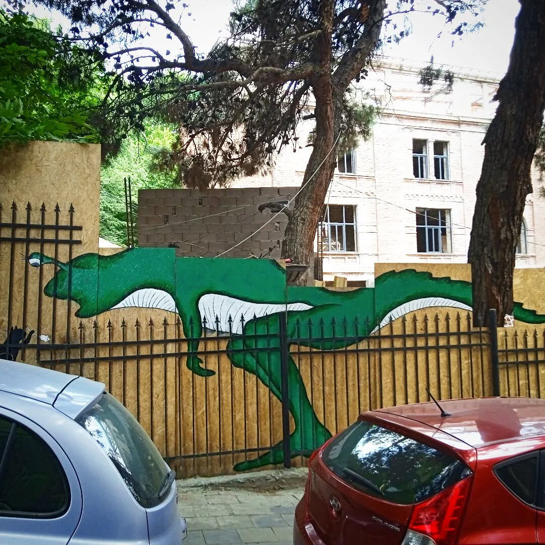 Black Cat feeding a Green Dino